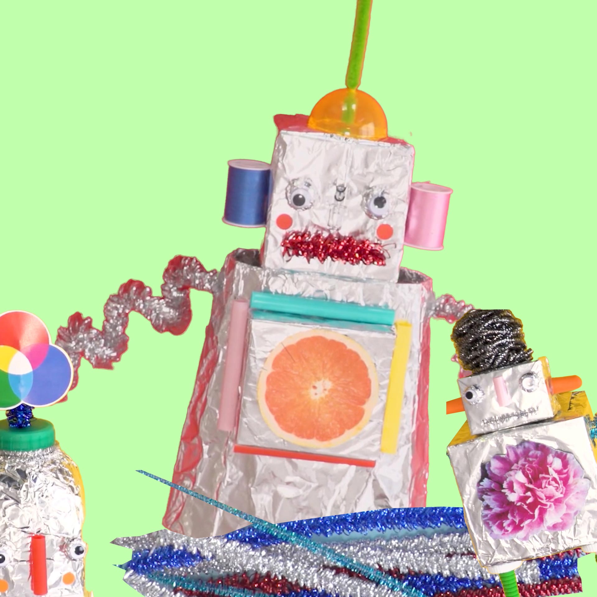 A robot made of tin foil and pipe cleaners on a lime green background