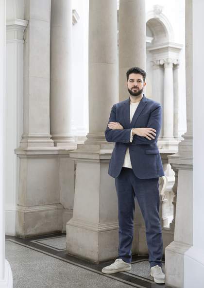 Tate Interim Managing Director Liam Darbon standing in front of pillars