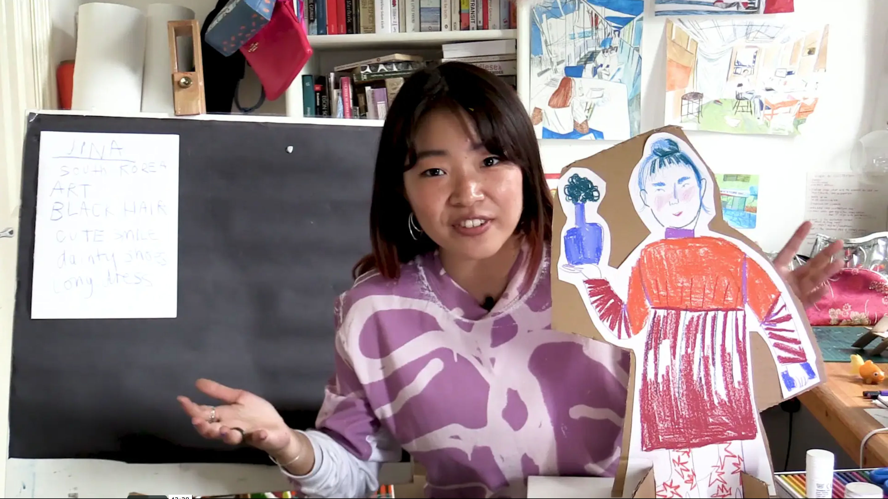 presenter joey yu holding up her cut out drawing